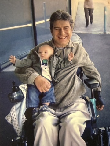 Greg Kidd in wheelchair with first Grandson Bailey his right arm in Melbourne